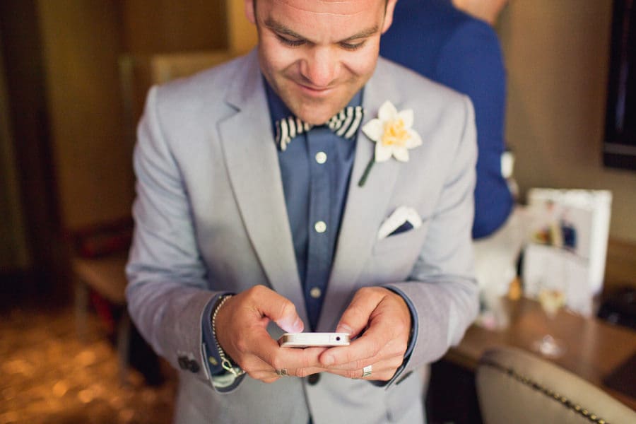 Groom texting at Loden Hotel Vancouver Elopement