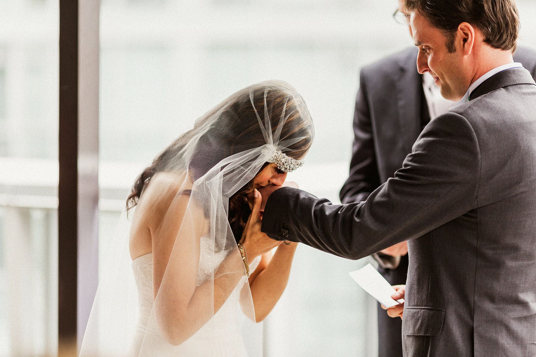 Bride kisses grooms hand