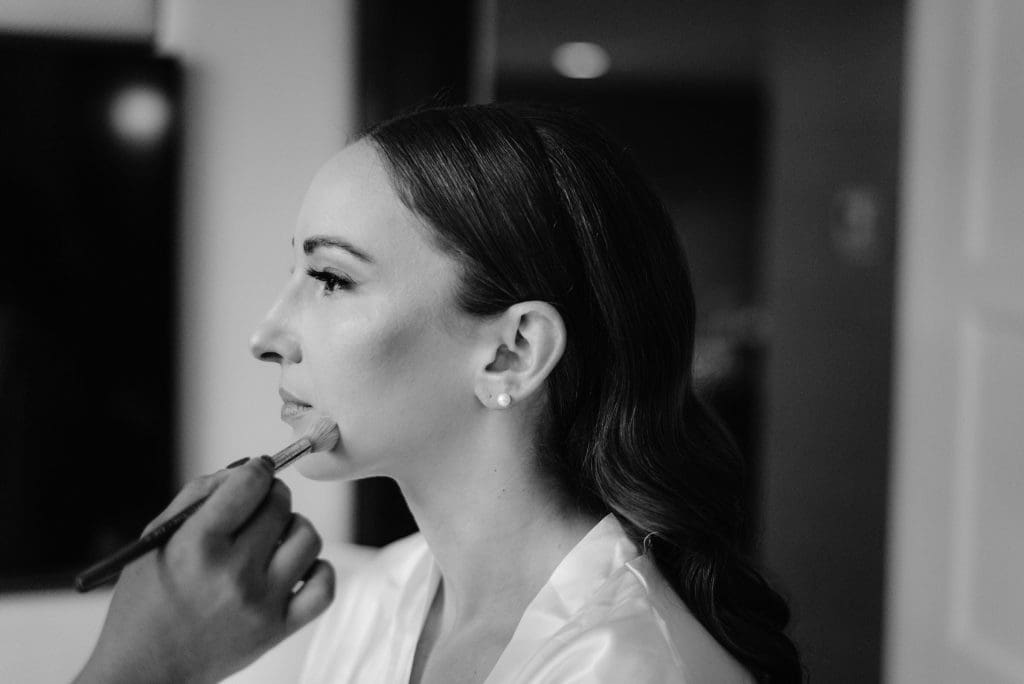 Black and White Image of Bride getting wedding make up 
