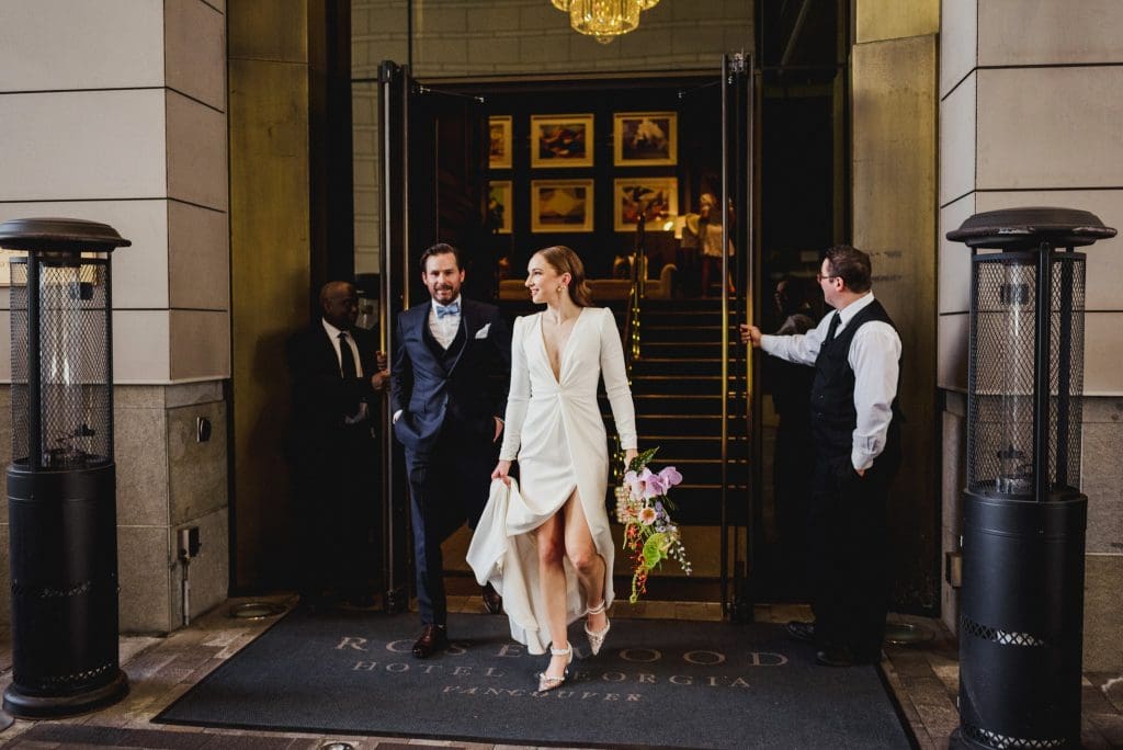 Bride and groom are leaving the hotel