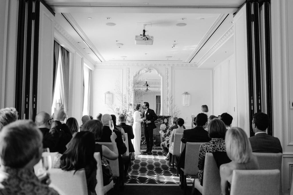 Timeless black and white moment as the bride and groom share their first kiss as husband and wife.