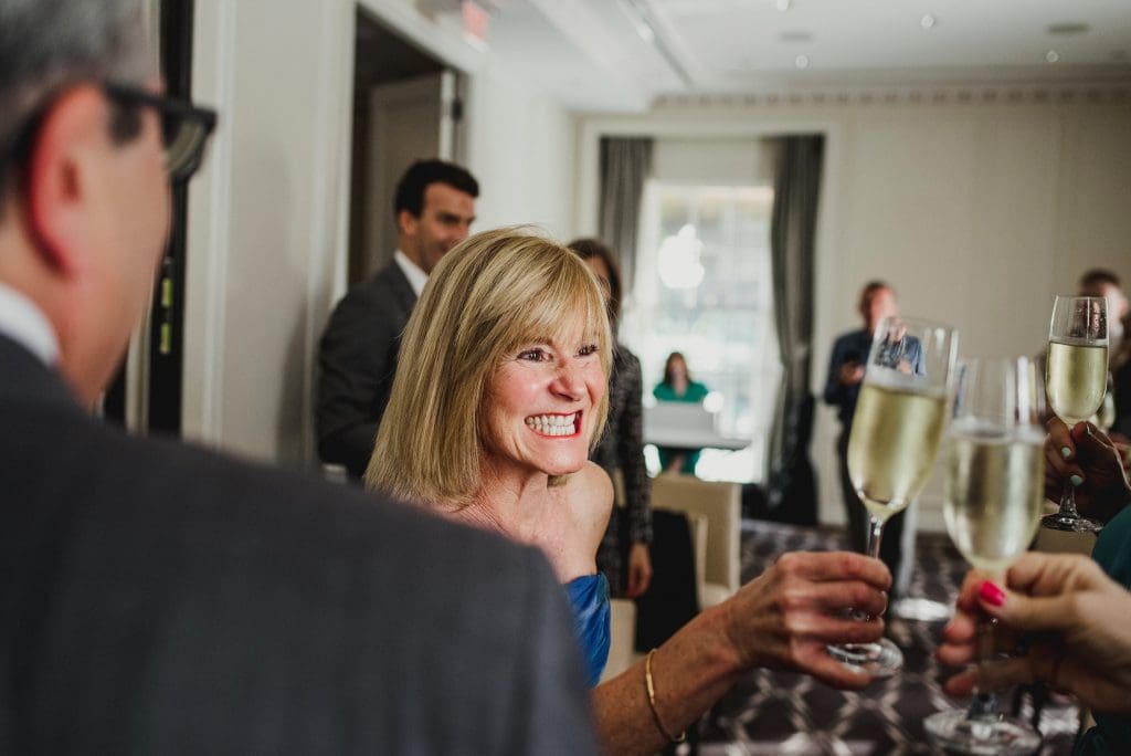 Family members raising glasses and sharing a wedding toast.