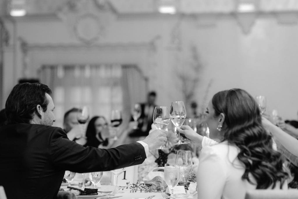 Family and friends raising a wedding toast during the reception to celebrate the bride and groom.